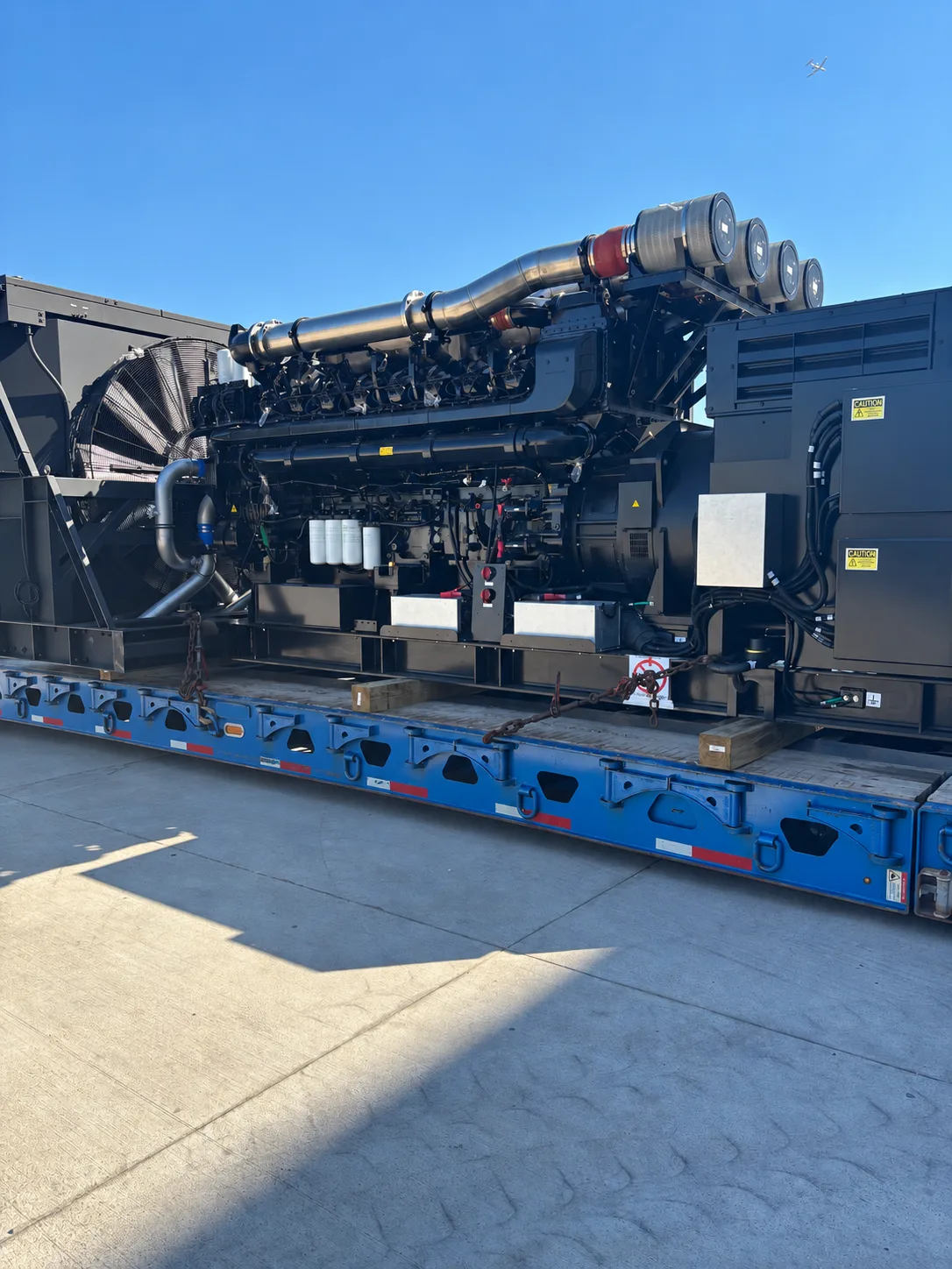 Industrial generator secured on a blue trailer