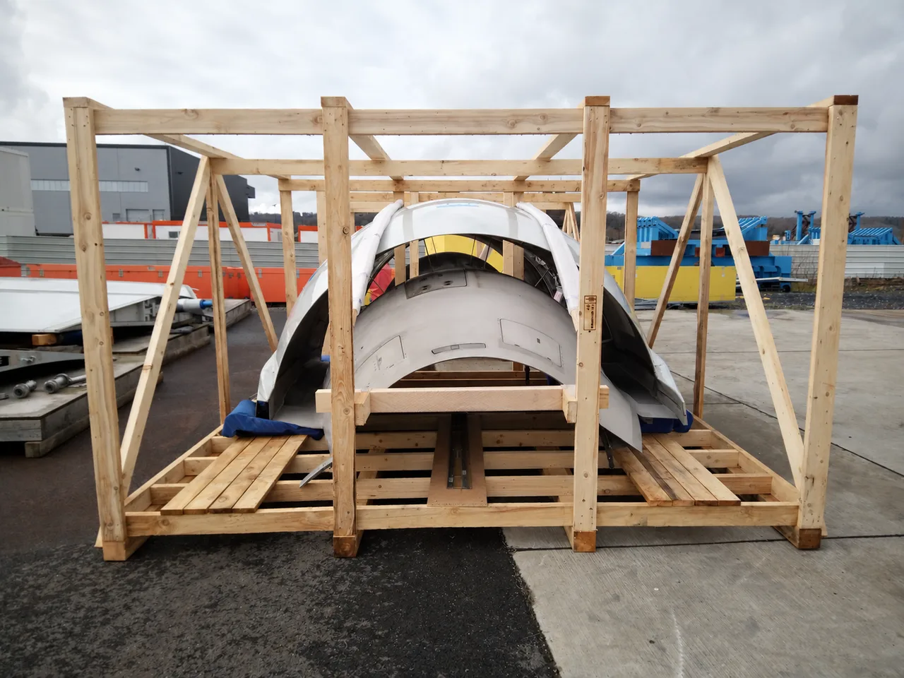 Aircraft components protected in a timber transport frame outdoors